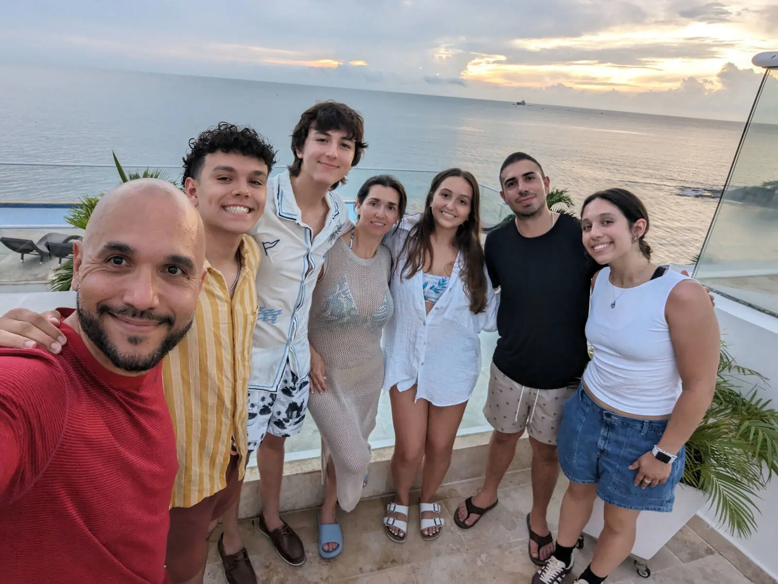 Mario, Lina, and their five children at sunset overlooking the ocean