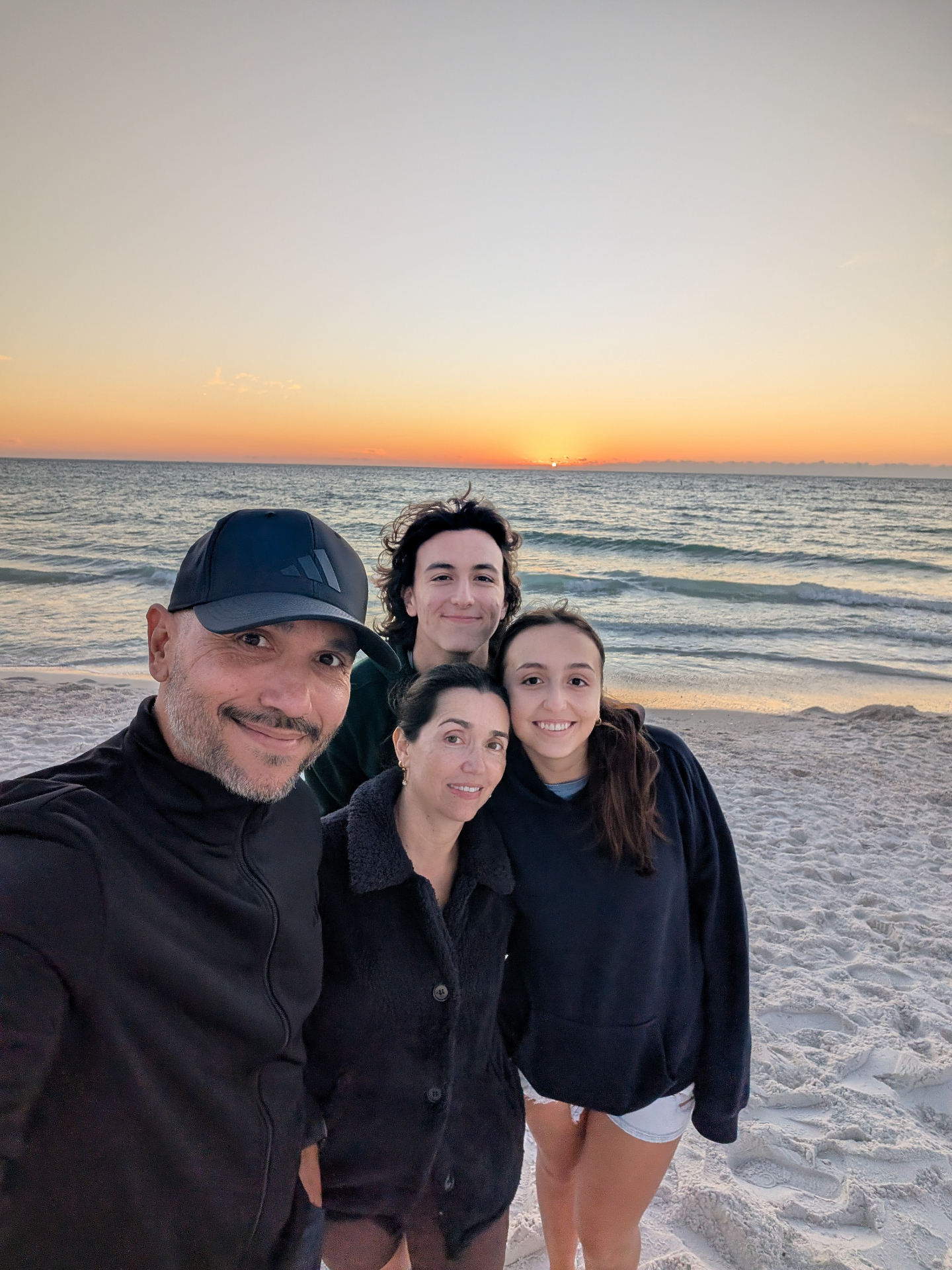 Mario, Lina and two of their kids at sunset on the beach