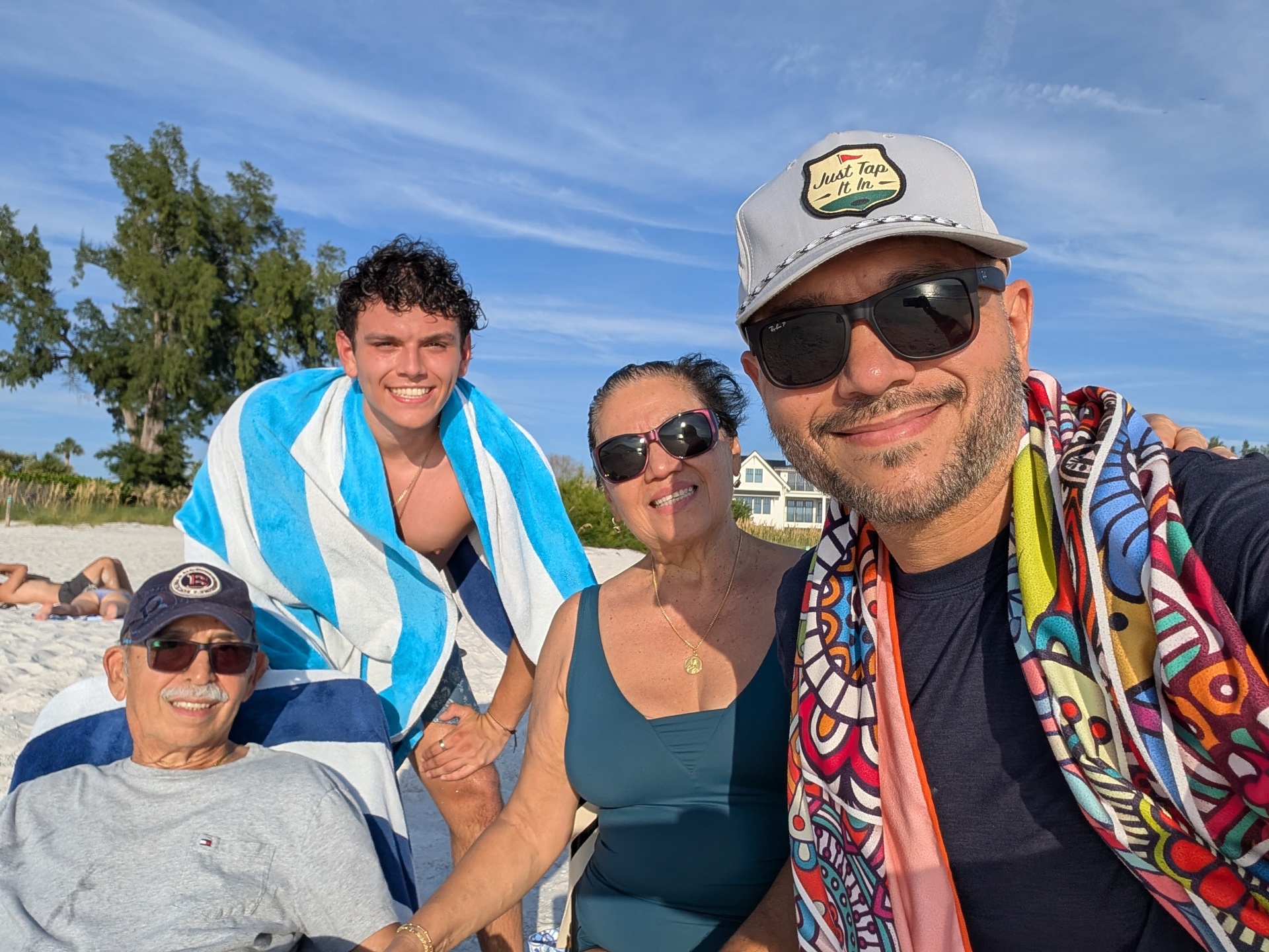 Mario with his parents and son on the beach