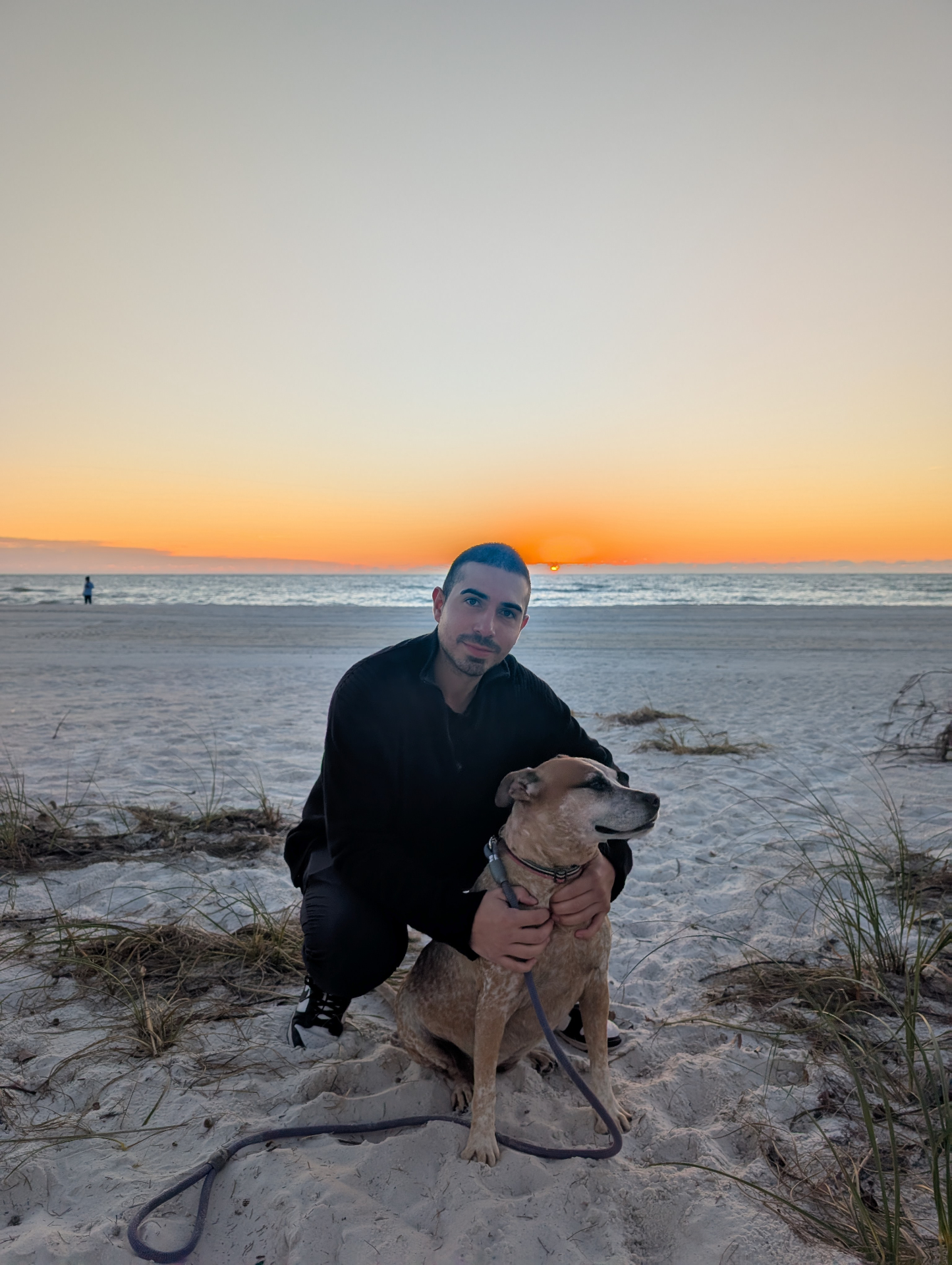 Our son with Happy the dog at sunset on the beach