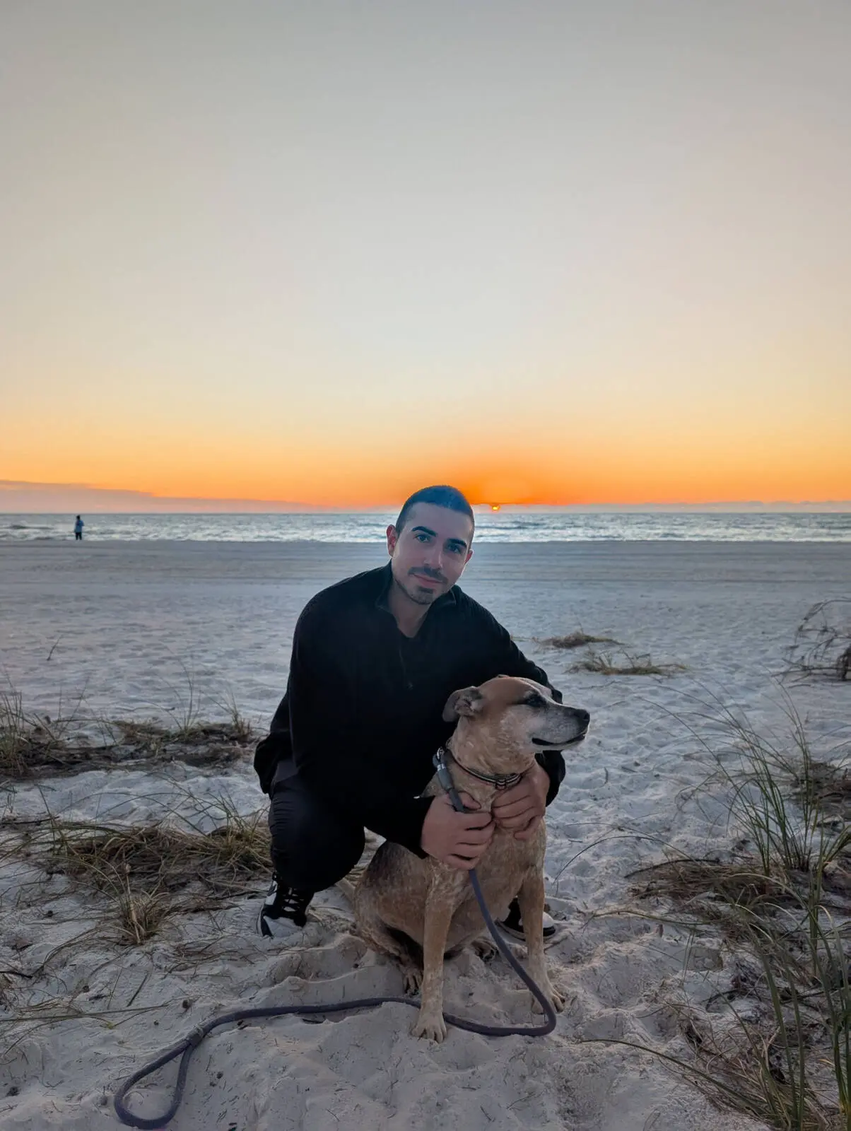Our son with Happy the dog at sunset on the beach